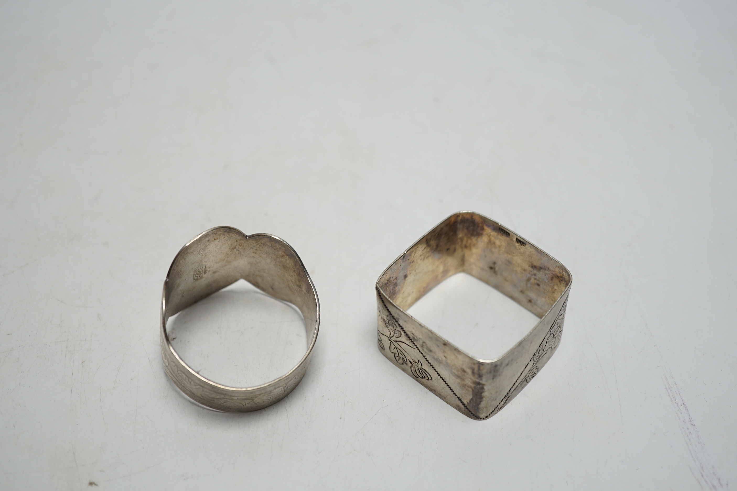 Two Chinese engraved white metal napkin rings.